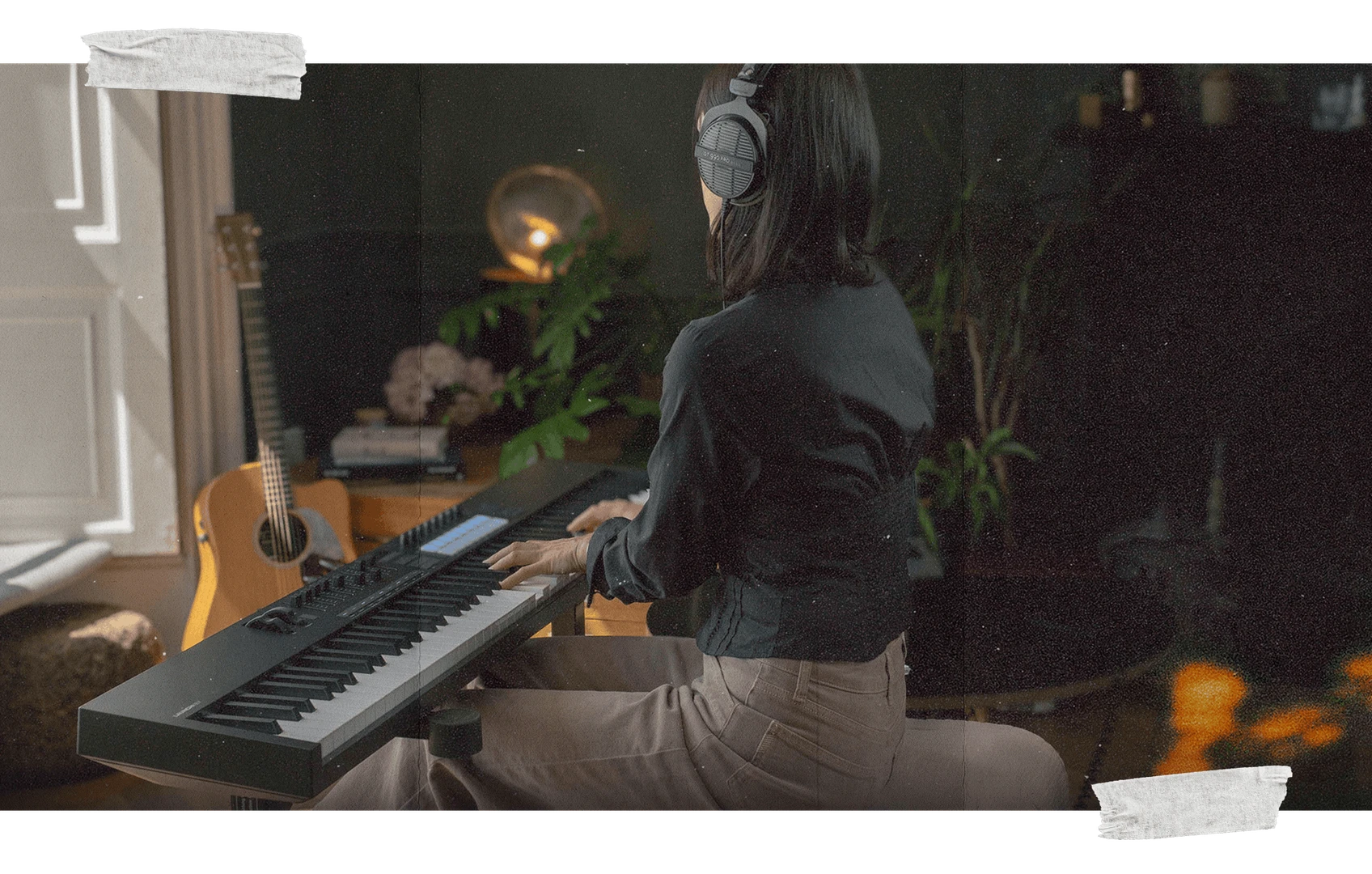 Novation Launchkey 88 MK4 being played by a seated musician wearing headphones in a home-studio environment