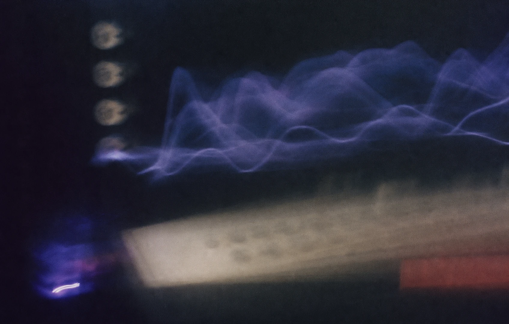 A moody editorial collage of ghostly waveform shapes, faded knobs, and hand-cut paper gradients floating over a dark studio-like field