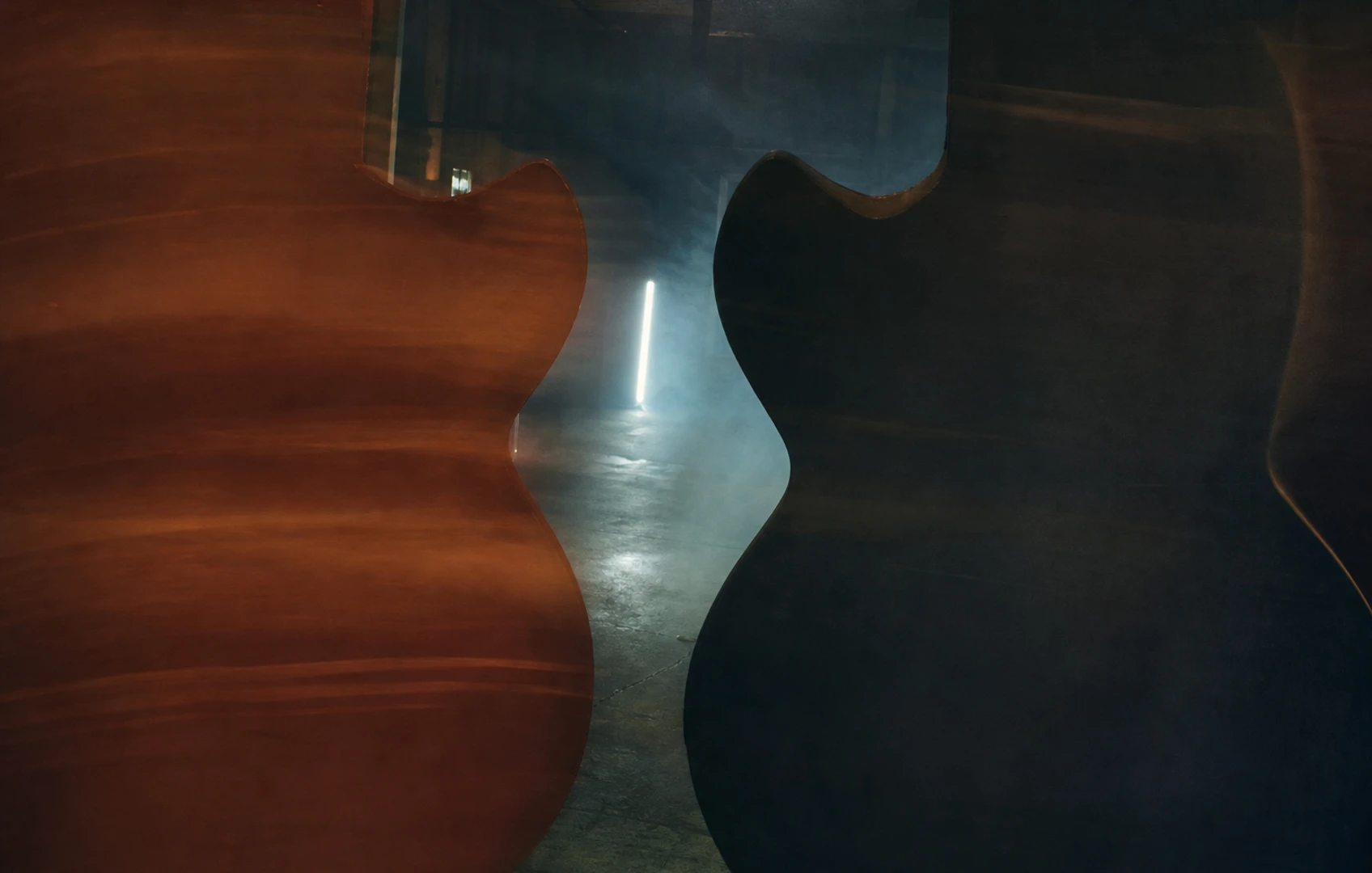 A rough cut-paper editorial illustration of offset and single-cut guitar silhouettes colliding like paper signs in a warehouse aisle, with torn edges, muted colors, and lots of negative space.