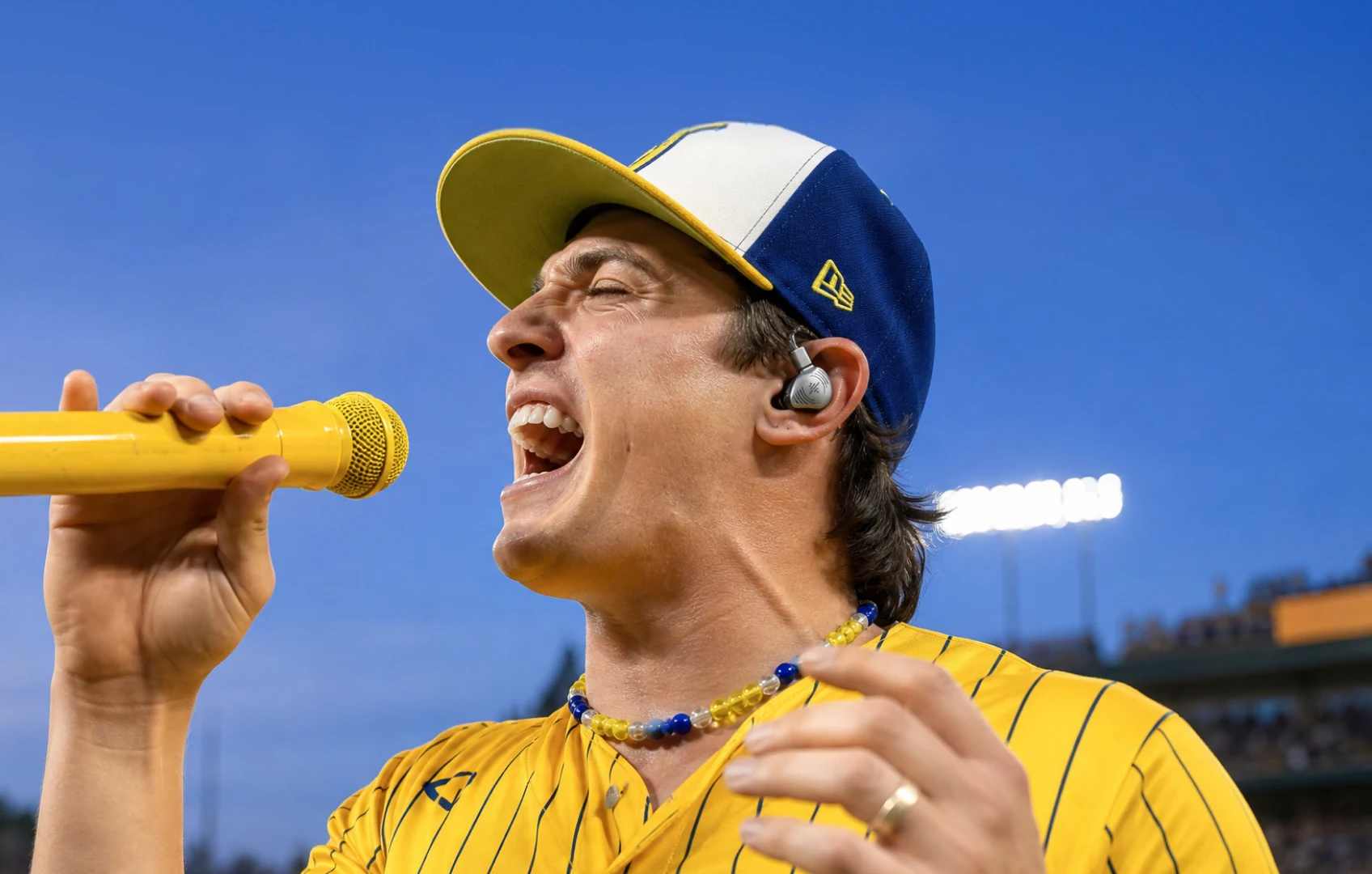 Male singer performing with wired Soundbrenner-style in-ear monitors visible in his ear